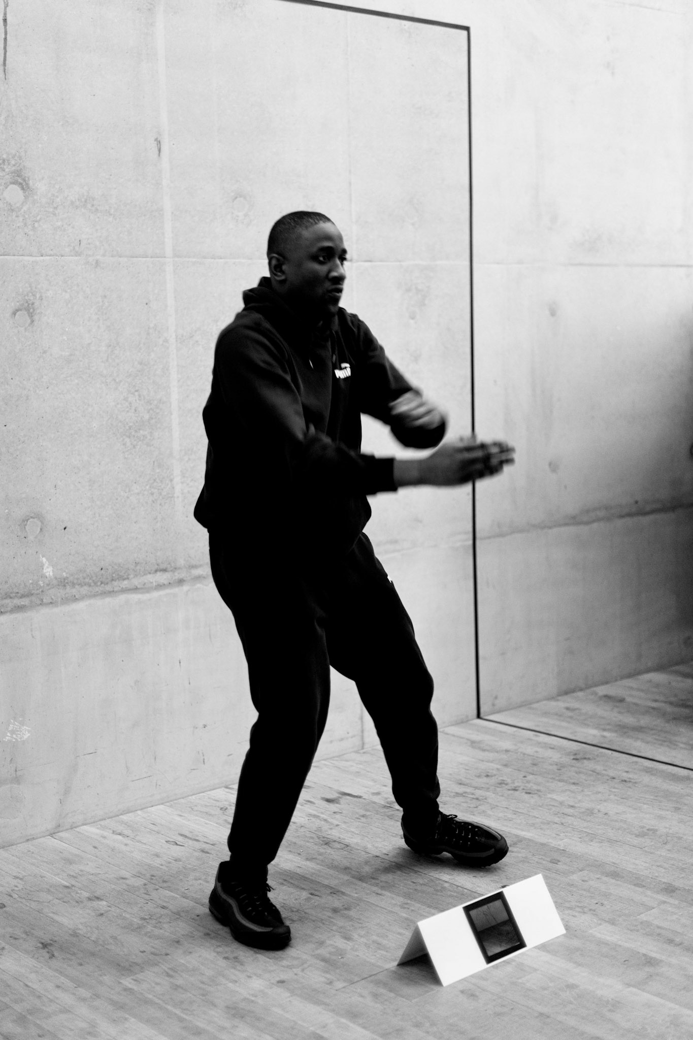 Black and white photo of Aaron dancing at Tate Modern