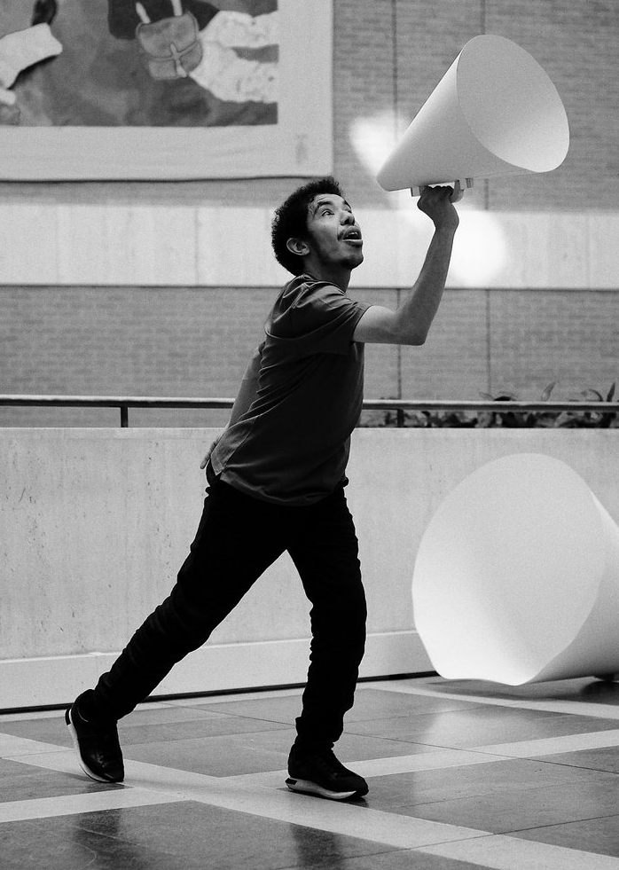 Black and white photo of DJ dancing with a cone at the British Library