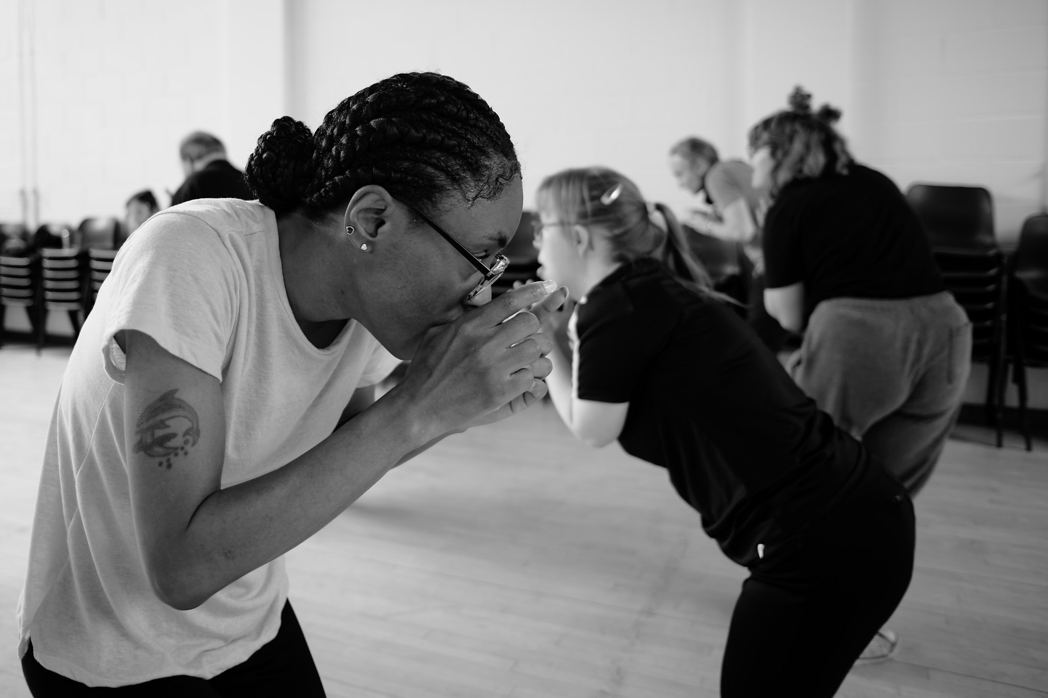 Black and white photo of Nicole dancing at Professional Development Class sharing